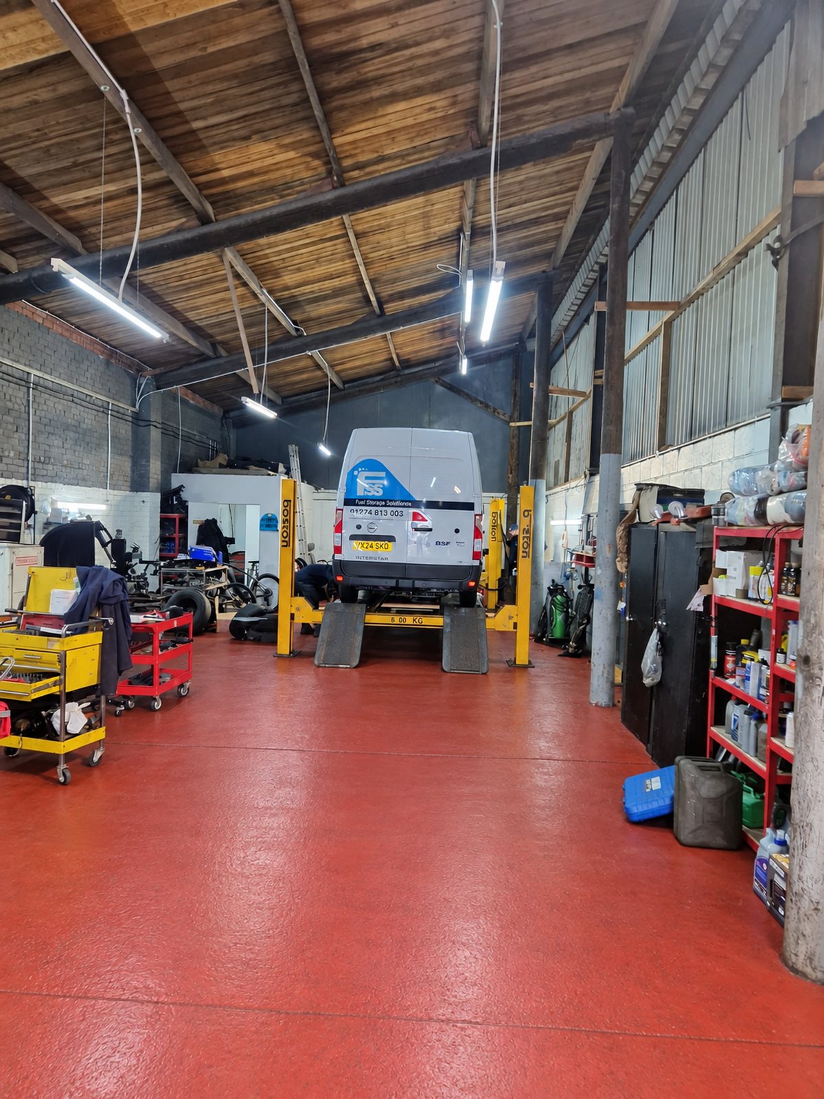 Inside the Oldfield workshop at Unit 18, with vehicles on the ramps